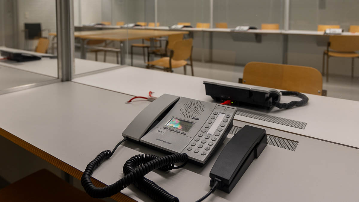 Kuvassa vankilan tapaamistiloja puhelinkoppeineen.